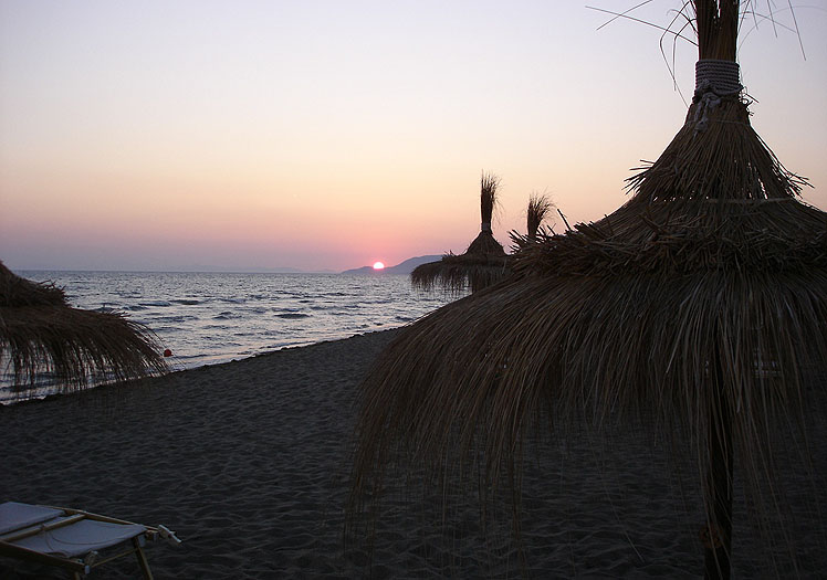 Tramonto con colori caldi sulla spiaggia del Fuorirotta Beach Club